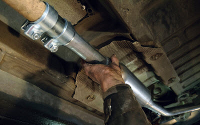 Toyota Mechanic Installing New Exhaust Pipe